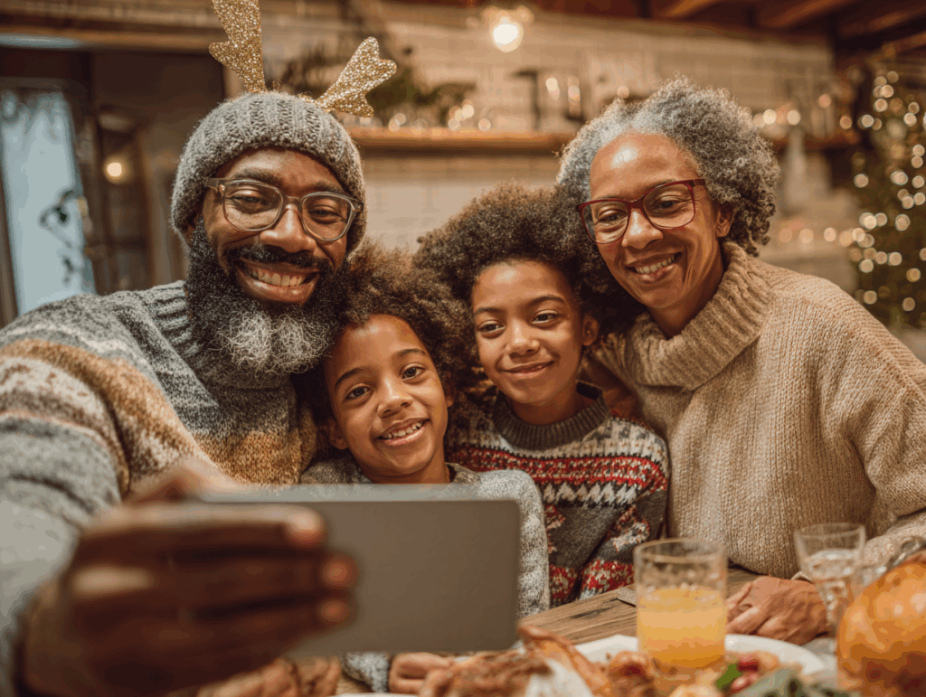 Grandparents and grandchildren taking a selfie at a festive dinner table with Christmas decorations in the background.